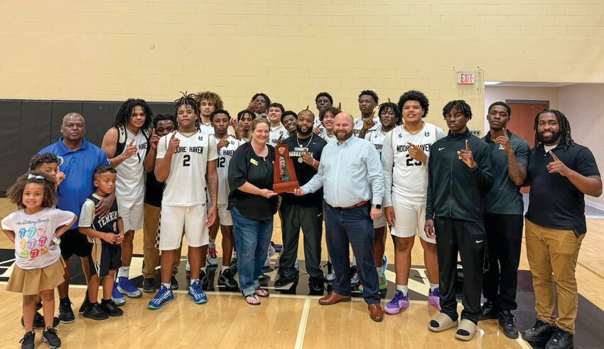 Glades County superintendent Beth Barfield celebrates with the Terriers following their district championship win. [Photo courtesy Moore Haven Athletics]