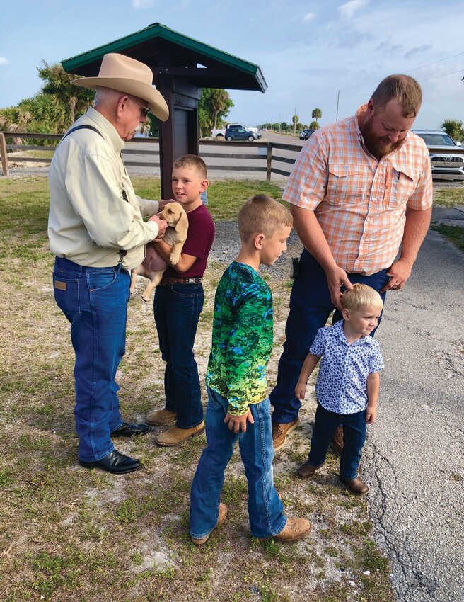 GLADES COUNTY -- Glades County Commissioner Jerry “Gator” Sapp speaks with some of the Thompson boys at Margaret Van de Velde County Park. [Photo by Patti Powers]