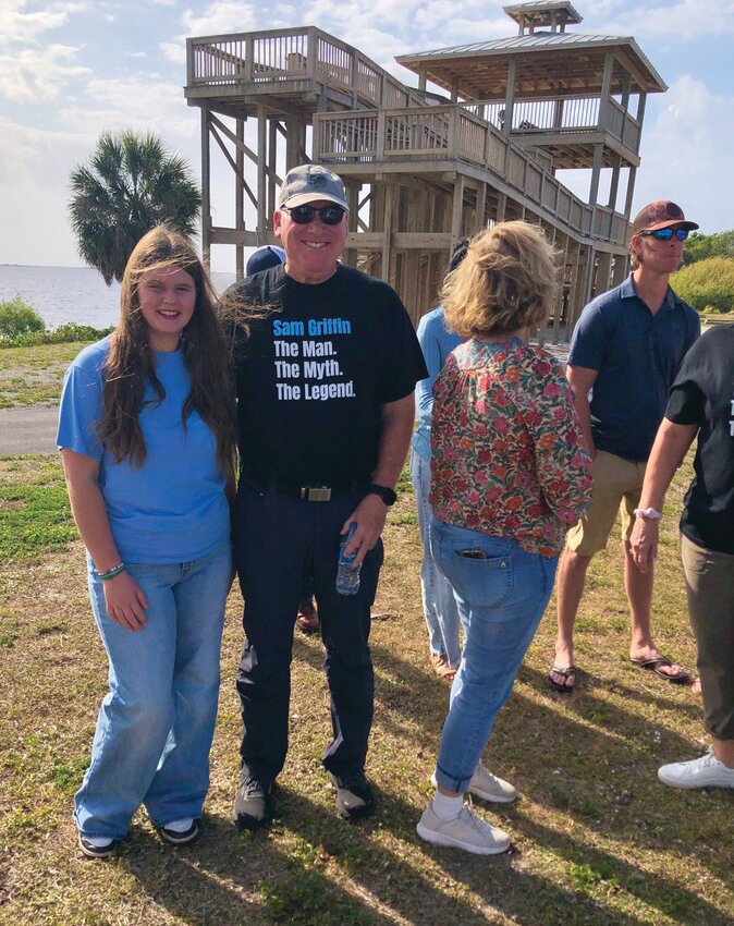 GLADES COUNTY -- Sam Griffin’s son, Samuel J. Griffin, and cousin Kenley Roberts gathered with other family members at the Sam Griffin Observation Tower for presentation of the commemorative sign installed by FGCP at Margaret Van de Velde County Park. [Courtesy photo]