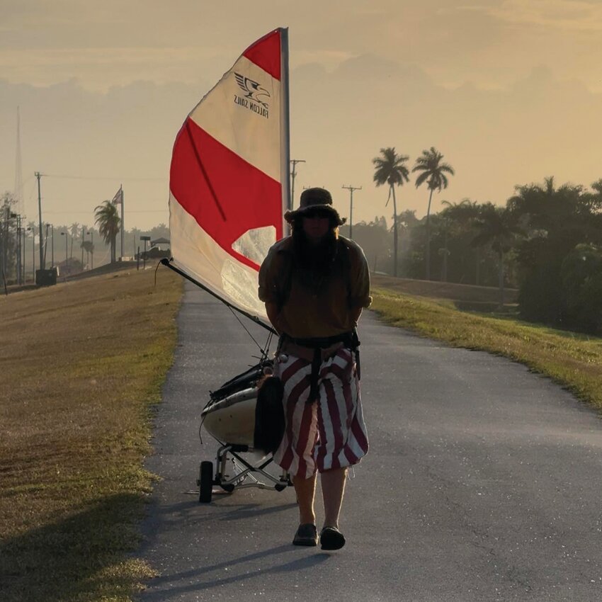 Peter carries his boat along the Herbert Hoover Dike. [Photo courtesy Peter Frank]