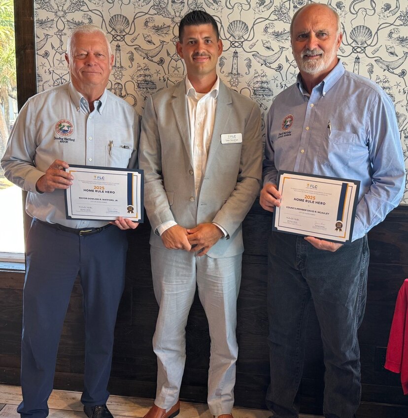 This year's Home Rule Heroes from the City of Okeechobee are Mayor Dowling Watford (Left) and Council Member David MCauley (Right) presented by Tyler Denahan of the Florida League of Cities.