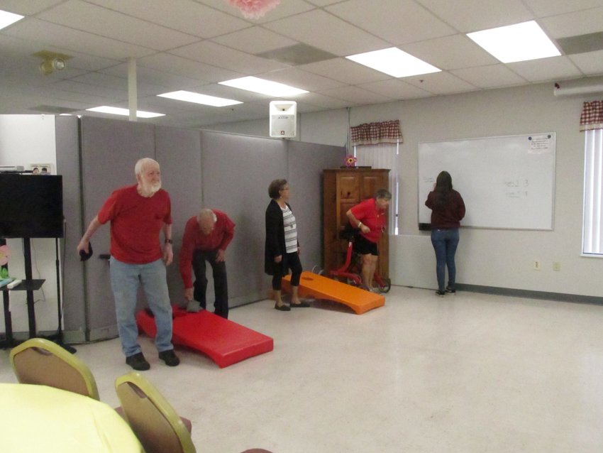 Clients of the Young at Heart Senior Center hold cornhole tournament.