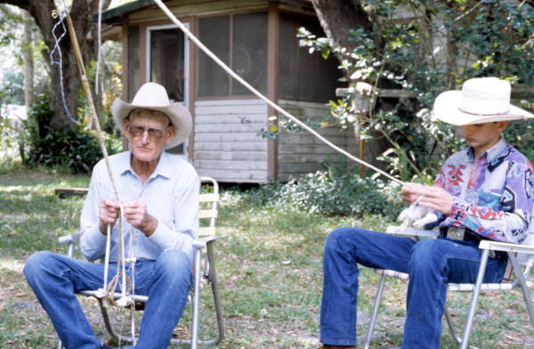 OKEECHOBEE  -- This 1994 photo shows apprentice J. Taylor Marcus being taught about the plaiting of cow whips from whip maker George &quot;Junior&quot; Mills.