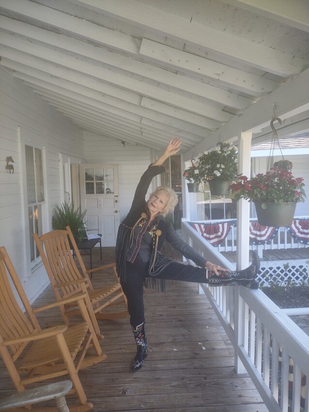 Nancy Dale took her yoga mat to practice postures on the porch dressed in cowboy boots and vest to do yoga and to tell the true stories written in her books of the Florida pioneer &ldquo;Cow Hunters.&rdquo;