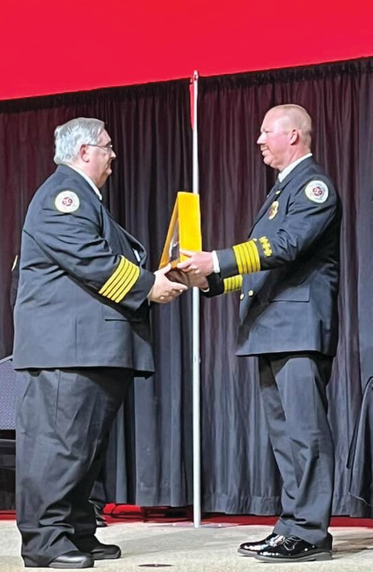 Departing Fire Chief Ralph Franklin (left) passes command to incoming Chief Earl Wooten II on April 28, 2023.