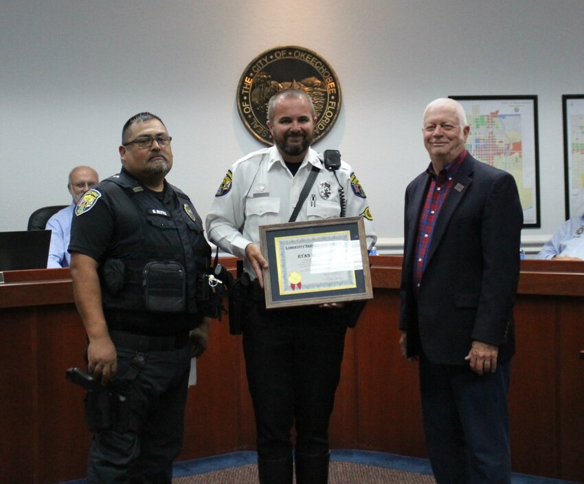 During the June 6 Okeechobee City Council meeting, Okeechobee City Police Officer Ryan Holroyd was presented with a longevity award for 15 years of service to the city. Pictured are Lt. Belen Reyna, Officer Holroyd and Mayor Dowling Watford.