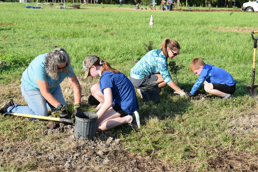 The Corps family pitches in to plant natives at W.P. Franklin Recreation Area.