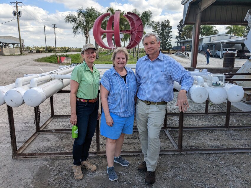 Our Chief Biologist, Dr. Anarie Lyles, and 2 guests standing beside our first robot for Lake Okeechobee.