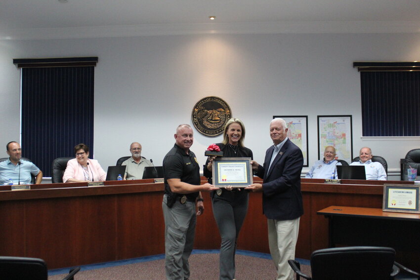 Detective Savanna Yates was honored for five years of service to the city of Okeechobee during the July 18 city council meeting. Pictured with Yates is Police Chief Donald Hagan (left) and Mayor Dowling Watford.
