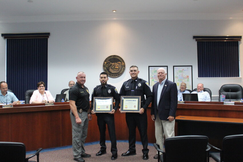Okeechobee City police officers Dalton Pitts and Rafael Castaneda receive awards for their part in saving a man's life. Pictured left to right are Police Chief Donald Hagan, Officer Rafael Castaneda, Officer Dalton Pitts and Mayor Dowling Watford.