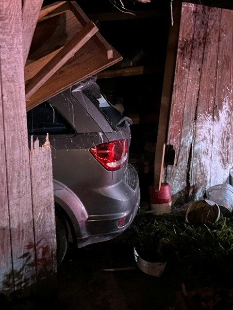 The vehicle came to a stop inside this shed.