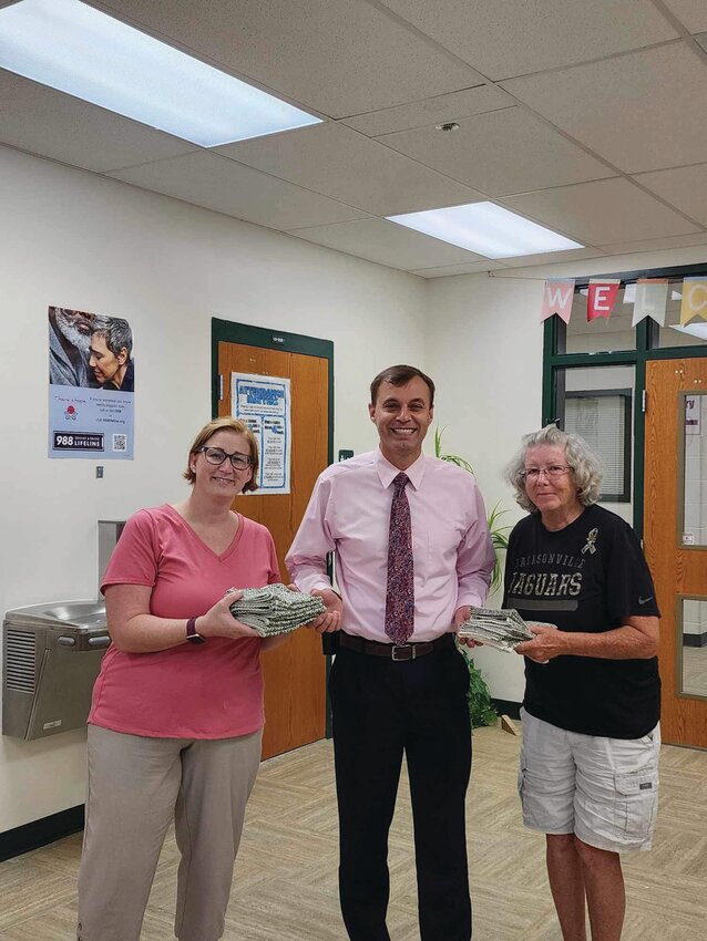 Sara Yates (left) and Dena Baker (right presented some of the safety curtains to OAA principal Audie Ash.