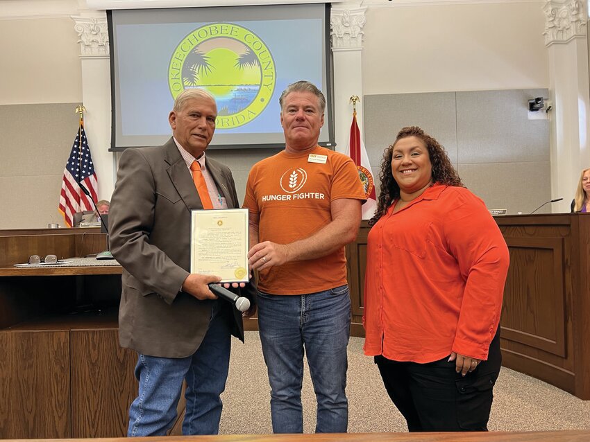 OKEECHOBEE &ndash; September is Hunger Action Month in Okeechobee County. At the Sept. 6 meeting, (left to right) Okeechobee County Commission Chairman David Hazellief (left) presented a proclamation to Michael Thompson, Food Procurement Manager for the Treasure Coast Food Bank and Andrea Santos, Retail Store Donation Coordinator. [Photo by Katrina Elsken/Lake Okeechobee News]