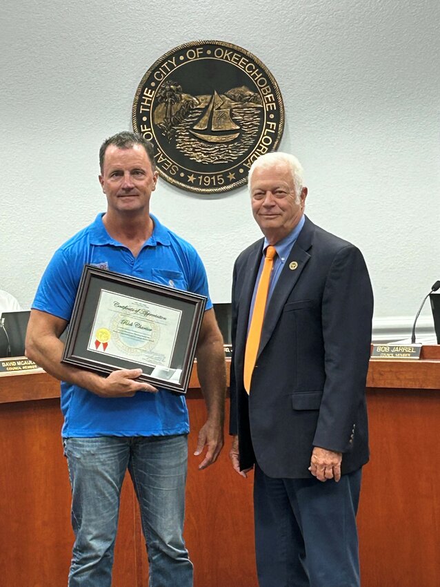 Mayor Dowling Watford (right) recognizes Rick Chartier for his years of service on the city's planning board.  Chartier recently moved out of the city but still owns and operates a business in Okeechobee.
