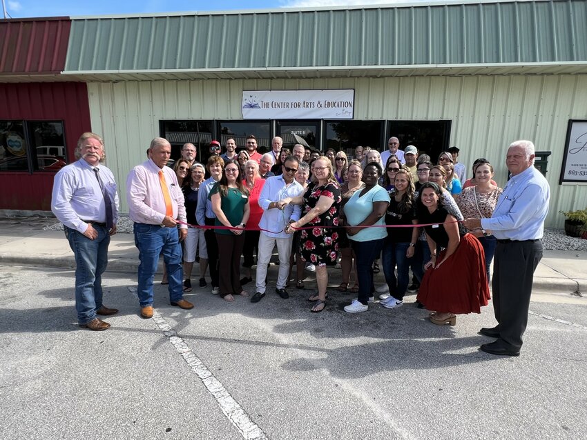 OKEECHOBEE -- Community members gathered at the Our Village Center for Arts and Education for the ribbon-cutting on Sept. 6.