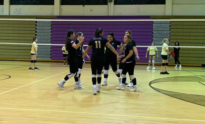 The JV Lady Brahmans celebrate after scoring a point against Moore Haven. [Photo courtesy OHS Lady Brahman Volleyball]