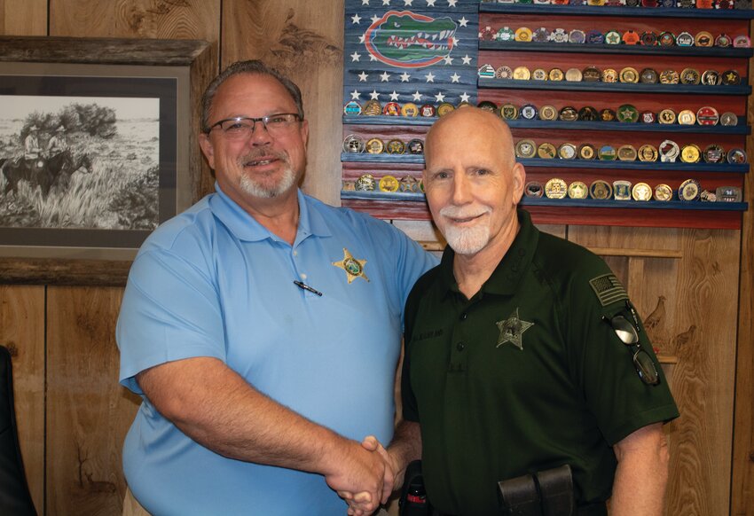 OKEECHOBEE -- Okeechobee County Sheriff Noel Stephen (left) congratulates Sgt. Mark Garland on his retirement. [Photo by Rick Lewis Sr./Lake Okeechobee News