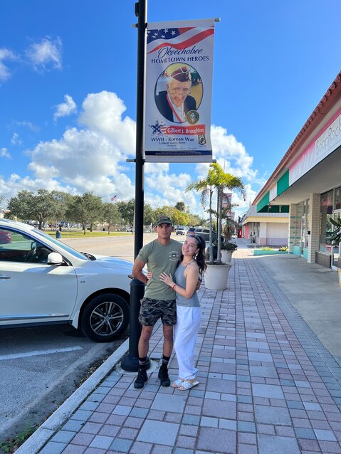 OKEECHOBEE -- Brittany Broughton surprised her husband Robert with a banner honoring his father. Robert is with the U.S. Army Reserve. [Photo by Katrina Elsken/Lake Okeechobee News]