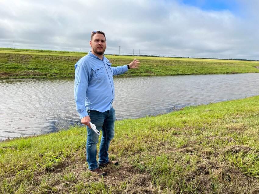 USACE Dam Safety Program Manager Matt Taylor (in front of the seepage canal that surrounds the C-44 reservoir) explained that all dikes have seepage.
