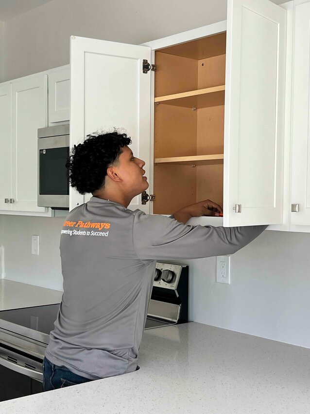 An Immokalee Foundation student works on the cabinetry at a Learning Lab home