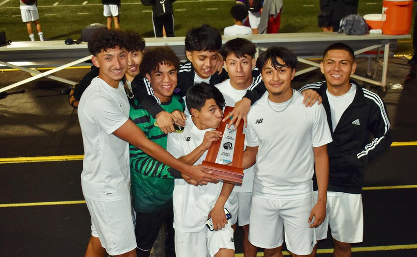 Brahman players celebrate with their trophy. [Photo courtesy OHS Boys Soccer]