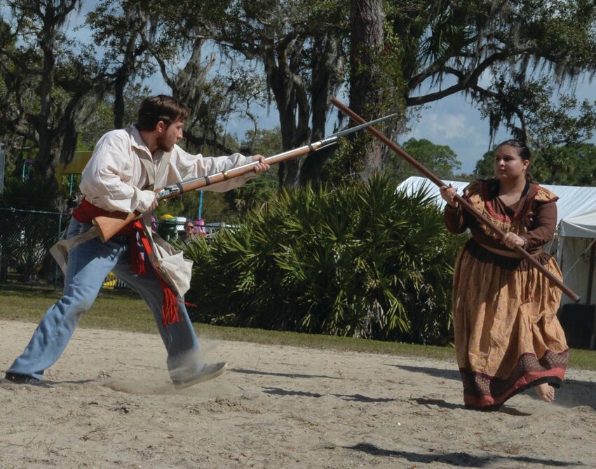 Oscole Warrior Legacy's demostration included information about how Seminole women took part in the Seminole Wars, carrying equipment for the men and engaging in combat themselves. [Photo by Katrina Elsken/Lake Okeechobee News].