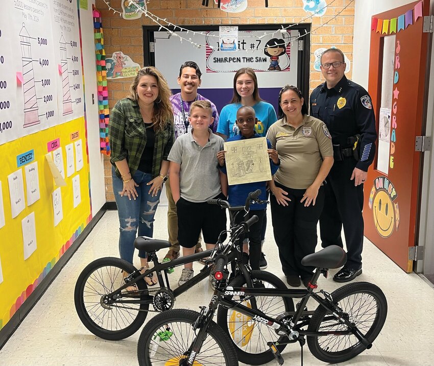 CLEWISTON --  Westside Elementary School winners to the Clewiston Animal Services art contest, Nicolas and Braden (a team effort), got new bikes for their efforts on bringing awareness to the shelter and the need to spay and neuter. Chief Lewis, Commander Brophy, and Shelter Manager Cruz presented the bikes in front of the whole class. Their artwork will be framed and permanently displayed at the shelter! [Photo courtesy Westside Elementary School]