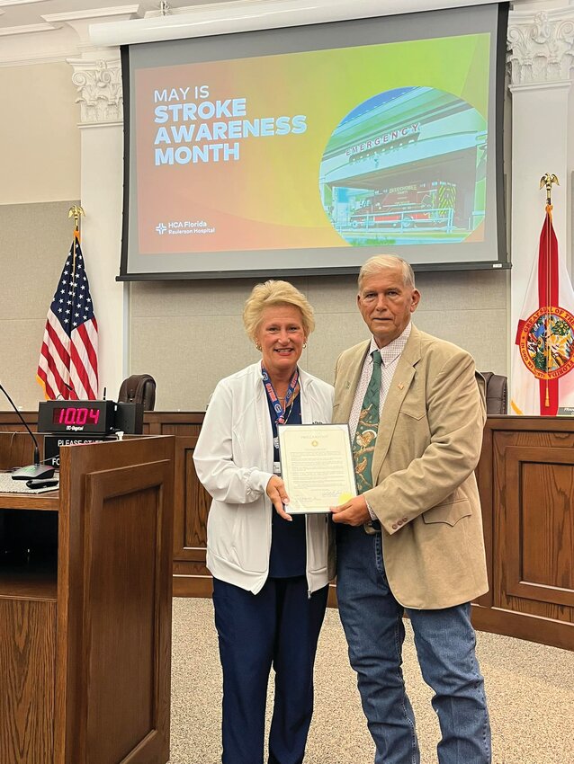 OKEECHBEE &ndash; Okeechobee County Commission Chair David Hazellief (right) presented Kathy Selby of HCA Raulerson Hospital with a proclamation for Stroke Awareness Month at the May 9 commission meeting. [Photo courtesy Okeechobee County Government]