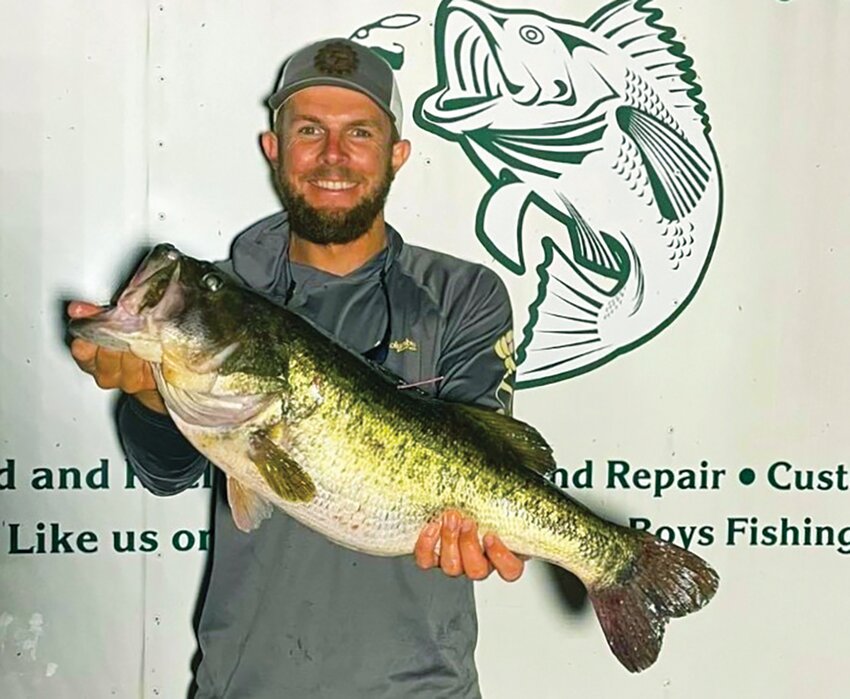 Harry Linsinbigler IV caught a prized, pink-tagged bass (11 pounds, 4 ounces) in Lake Rochelle, one of the Northwest Winter Haven Chain of Lakes.
