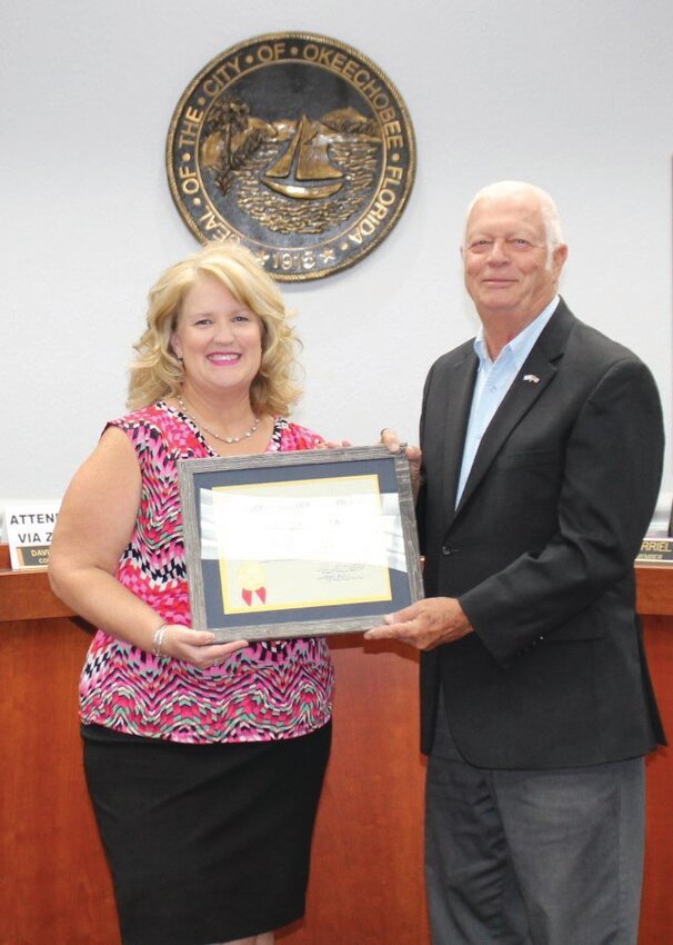 City Clerk Lane Gamiotea was recognized for 35 years of service to the city of Okeechobee during the July 16 city council meeting. Maor Dowling Watford presents her certificate and gift..[Photo courtesy city of Okeechobee]