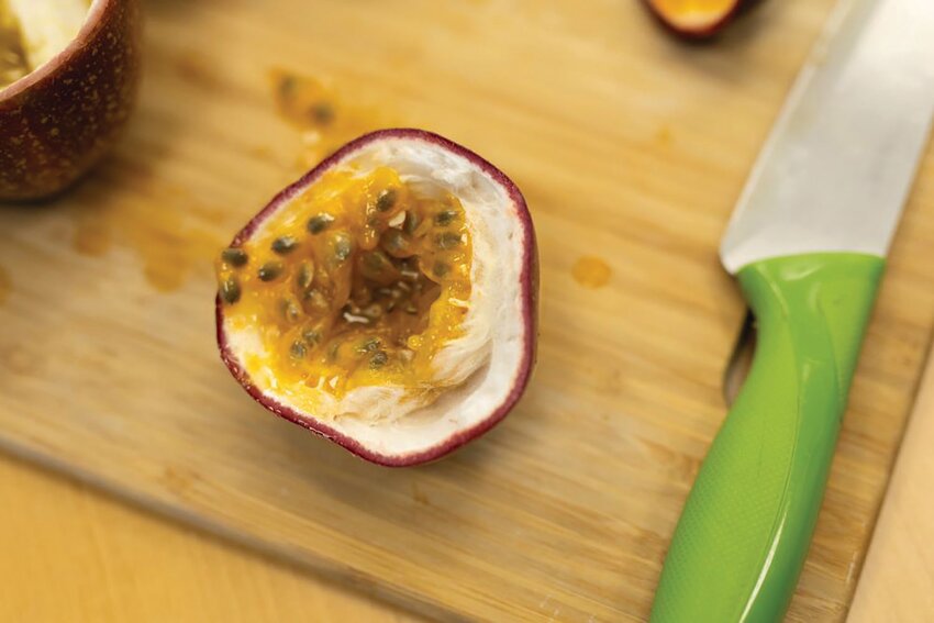 Picture of a passion fruit cut open. [Photo by Tyler Jones/ UF/IFAS]