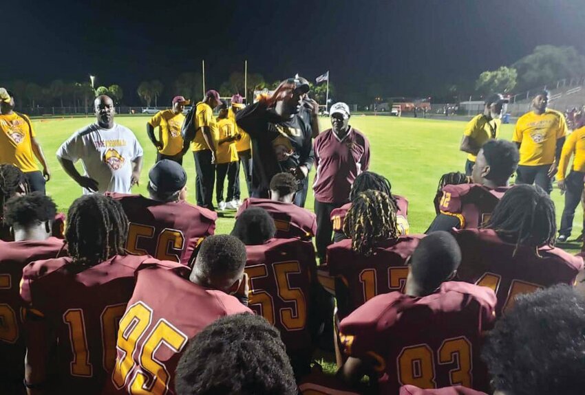 New head coach Omar Haugabook addresses his team. [Photo courtesy Palm Beach Schools Police Department]