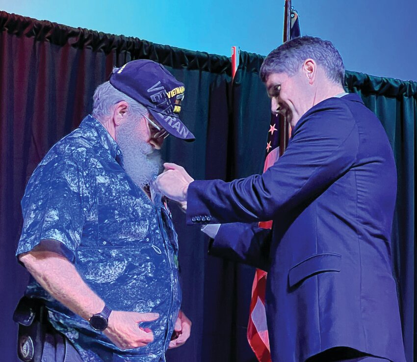 OKEECHOBEE -- Congressman Scott Franklin (right) officiated in a pinning ceremony to honor Vietnam War era veterans. [Photo by Katrina Elsken/Lake Okeechobee News]