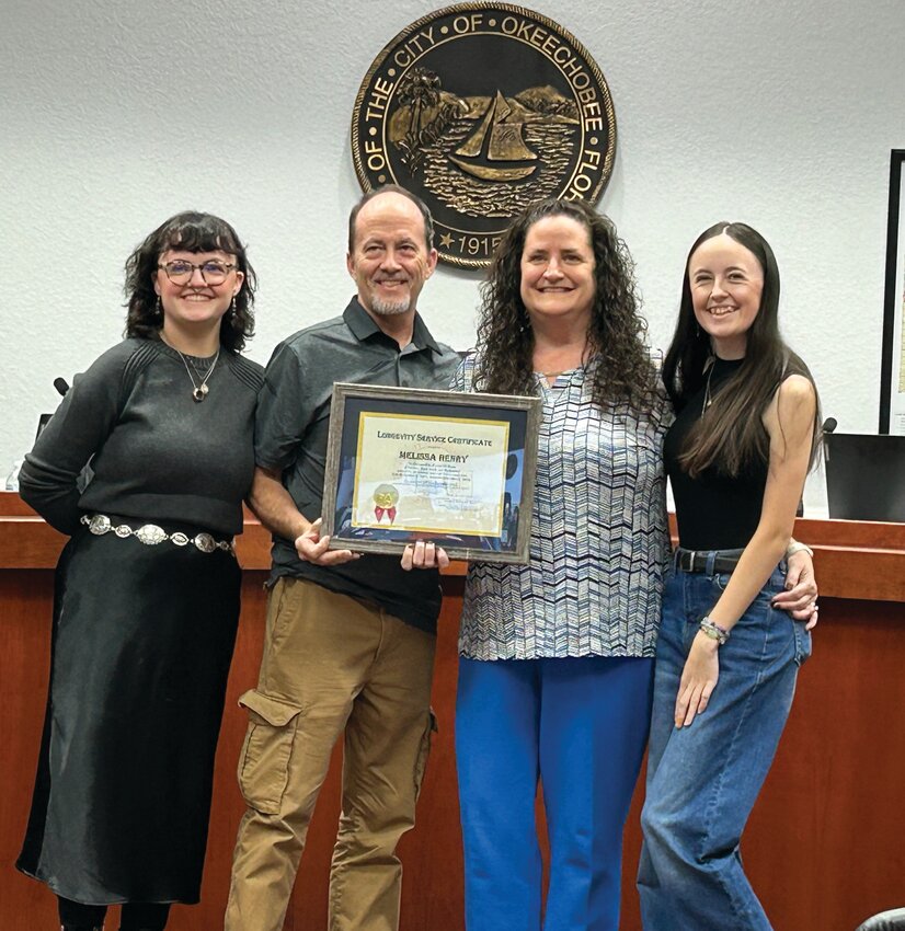 Melissa Henry and family celebrate her 10 year anniversary with the city..[Photo by Cathy Womble/Lake Okeechobee News]