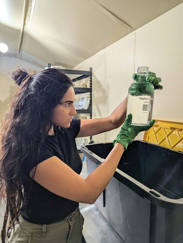 Analise Fussell reviewing water samples during testing phase. [Photo Courtesy Lourdes Mederos]