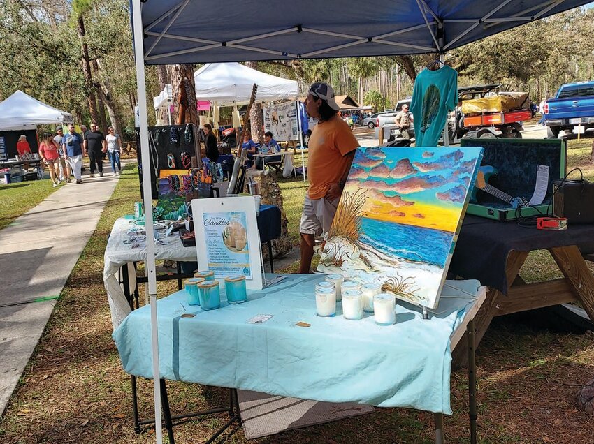 Arts and crafts vendor with paintings and candles at the 2024 Civilian Conservation Corps Festival.