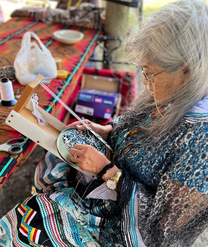 BRIGHTON -- Nancy Shore worked on traditional beadwork in the native village at the Brighton Field Day on Feb. 15. [Photo by Katrina Elsken/Lake Okeechobee News]