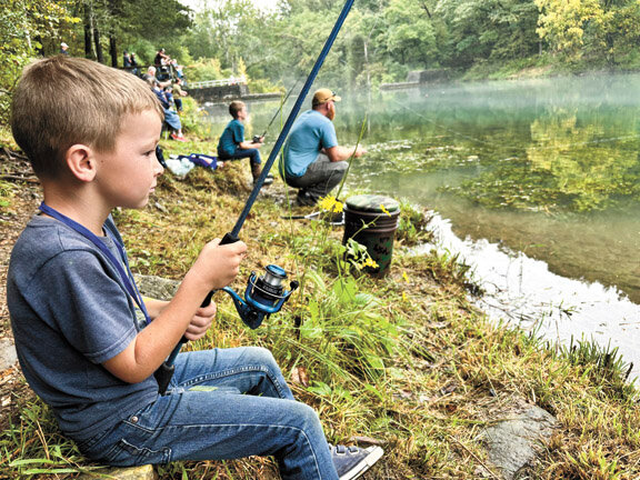 Juduh Spray, 6, waits patiently for the bicycle winning bite that did not come Saturday during the annual Mirror Lake Fishing Derby. See story and photos in the Sept. 18 issue.