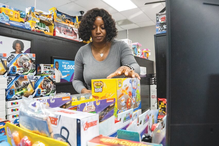 Tanya Wright, tax preparer and administrative assistant at Jackson Hewitt Tax Services in Sumter, organizes gifts for the annual Toys for Tots fundraiser.