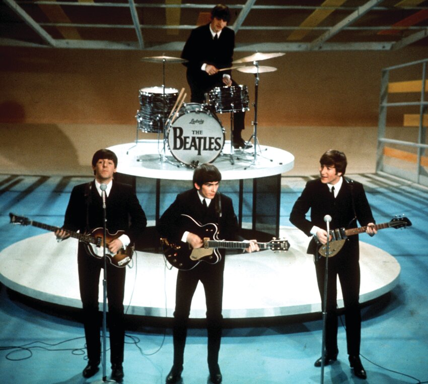 The Beatles, foreground from left, Paul McCartney, George Harrison, John Lennon and Ringo Starr on drums perform on the CBS &quot;Ed Sullivan Show&quot; in New York on Feb. 9, 1964.