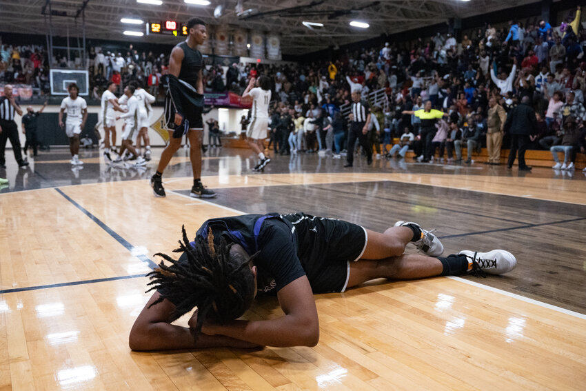 Crestwood's Aaron Coleman lies on the floor after the final buzzer sounds on the Knights' 55-52 overtime loss to Lower Richland on Wednesday in the 3A state quarterfinals.