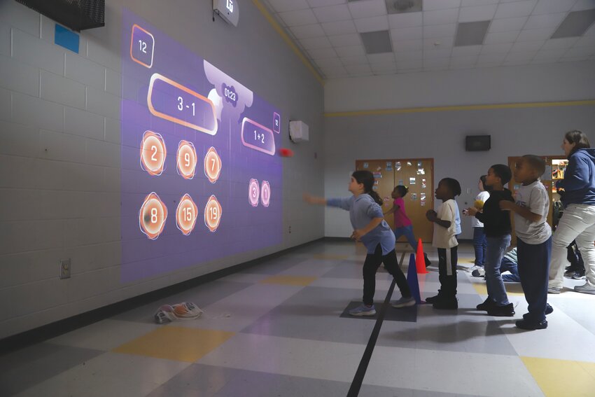 Oakland Primary School students participate in a cross-curricular activity involving throwing and math with Lu technology on Thursday. The school implemented the new technology in its physical education classes in January.