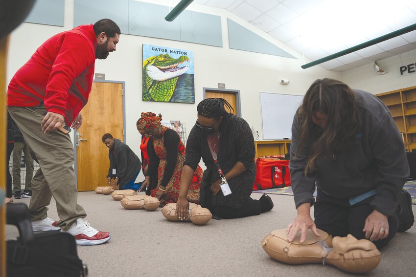 Lakewood High School staff train with CPR kits donated to the school by Roy and Meg Creech at the school Wednesday, Feb. 14.