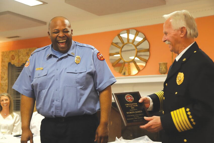 Manning Fire Engineer Byron James is all smiles as he receives the Firefighter of the Year award at Manning Fire Department's annual banquet on Monday, Feb. 26, presented by Manning Fire Chief Mitch McElveen.