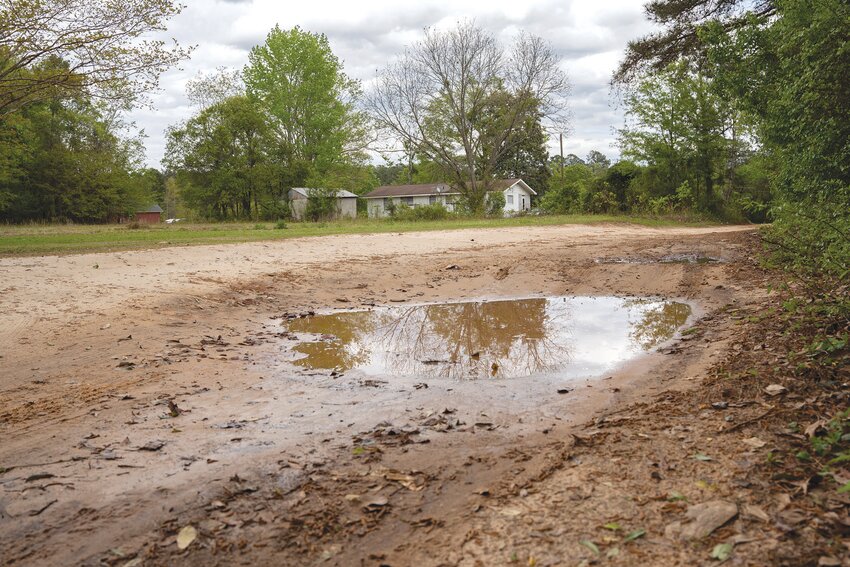 Shakemia Road in Sumter County is often flooded with water in potholes, with an uneven surface that makes traveling along it difficult.