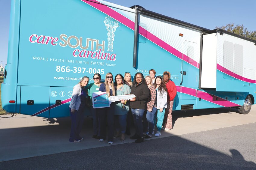 Staff members stand in front of the new mobile unit for CareSouth Carolina.
