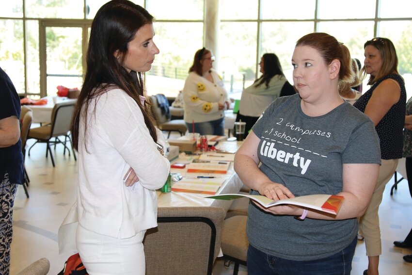 Teachers Ashley Stokes, left, from St. Anthony Catholic School in Florence, and Alicia Timmons from Liberty STEAM Charter School participate in a group activity at Saturday's workshop at Wilson Hall.