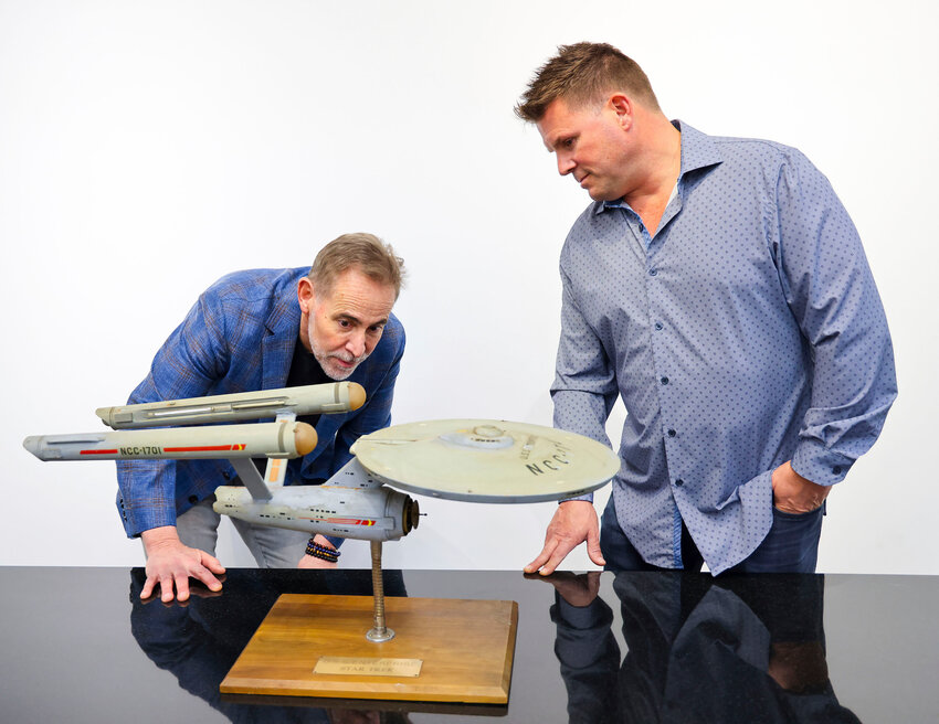 Joe Maddalena, executive vice president of Heritage Auctions, left, and Eugene &quot;Rod&quot; Roddenberry, the son of &quot;Star Trek&quot; creator Gene Roddenberry, view the recently recovered first model of the USS Enterprise at Heritage Auctions in Los Angeles on April 13. The model - used in the original &quot;Star Trek&quot; TV series - has been returned to Gene, decades after it went missing in the 1970s.