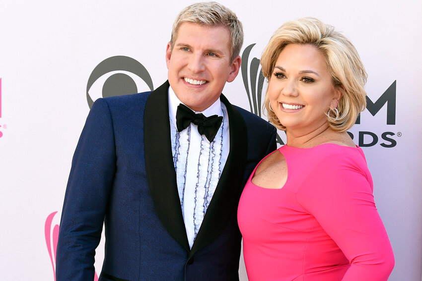 Todd Chrisley, left, and his wife, Julie Chrisley, pose for photos at the 52nd annual Academy of Country Music Awards on April 2, 2017, in Las Vegas.  Todd and Julie Chrisley, who are in prison after being convicted on federal charges of bank fraud and tax evasion, are challenging aspects of their convictions and sentences in a federal appeals court.