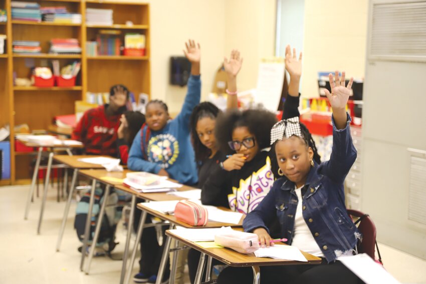 Crosswell Drive Elementary School fifth-graders raise their hands to answer a classroom question on Wednesday, May 1.